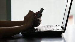 Using Smart Phone And Laptop Stock Footage