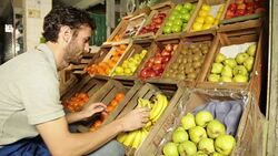 Man organizing fruist in a greengrocery Stock Footage