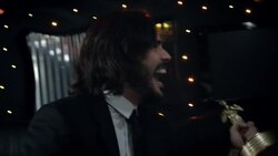 Excited celebrity cheers for paparazzi and kisses Oscar statuette in backseat of limousine at awards show Stock Footage