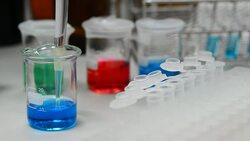 Dropping blue liquid into eppendrof from auto pipette Stock Footage