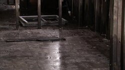Soaked floor tiles, stained wall studs, and a window frame are on the floor of a building damaged by floods after Hurricane Katrina. Stock Footage