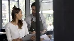 Happy couple ready to make their order to the waiter Stock Footage