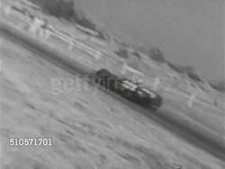 1965: AUTO RACING: HA XWS Race track w/ crowd of people & cars. VS People w/ Stock Cars, Backdraft Roadsters, Track Roadsters, Open Cockpit racing cars, VS Male drivers putting on helmets, Sport Cars racing on track, RAPID PAN CROWD BLUR. Instructional Video