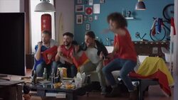 Sport fans sitting on couch watching tv and cheering Stock Footage