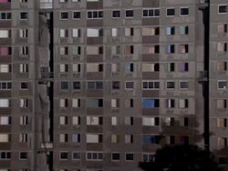 MS CU  Apartment building is demolished in controlled implosion using explosives and dissappearing cloud of dustin night / Sighthill, Scotland, UK  Stock Footage