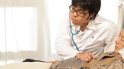 Doctor checks senior patient with stethoscope Stock Footage