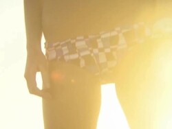 Young woman on beach, silhouetted in sunlight, Cape Town, South Africa Stock Footage