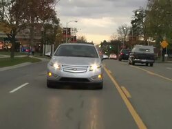 WS POV Electric car being driven in city traffic / Rochester, Michigan, United States Stock Footage