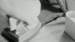 1943 MONTAGE John's suit being taken apart, and new clothing cut from its pieces / United Kingdom Stock Footage