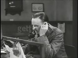 1917 DRAMATIZATION: INT Western Union telegraph office male using candlestick telephone, reading telegram to recipient, 'Three more ships torpedoed...President moves up Special Secession of Congress to April 2nd, signed Sergeant of Arms' Instructional Video