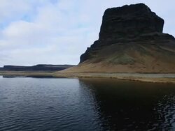 MS Shot of Choppy lagoon and mountain under blue sky/ Iceland Stock Footage