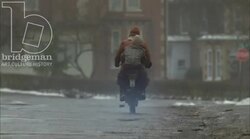 Man and boy riding on a motorbike, 1930s - reenactment, clip 2 Stock Footage