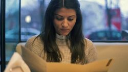 Beautiful young woman reading the menu. Stock Footage
