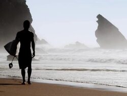 Surfer walking at the beach Stock Footage