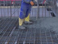 Workers Directing Concrete Onto The Construction Site Stock Footage
