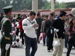 MS People walking near standing soldier at Forbidden City / Beijing, China Stock Footage