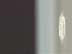 Water droplet falling into water, high speed Stock Footage