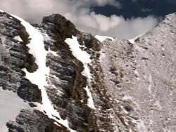 AERIAL past rocky snow-covered peaks of Rocky Mountains / Kalispell, Montana Stock Footage
