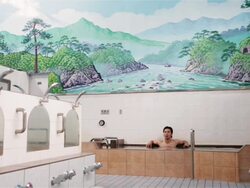 WS A man sits in a traditional Japanese public bath house or sento / Tokyo, Japan Stock Footage