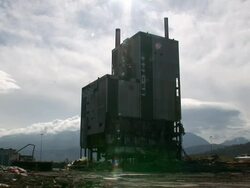 WS Mill building as it is demolished in  controlled implosion using explosives  / Fort William, Scotland, UK Stock Footage