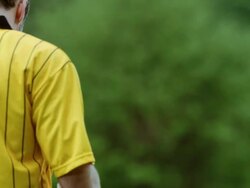 MS referee showing yellow card on field to professional soccer player arguing call Stock Footage