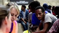 CLEAN : Red Cross helps migrants in Milan train station News Clip