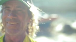 Old Brazilian fisherman laughs and smiles in the sunlight on Copacabana Beach Stock Footage