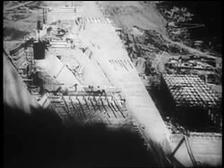 B/W 1930s high angle tilt up dam construction site / Tennessee River Valley Stock Footage