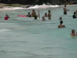 Kona coast beach people in waves Stock Footage