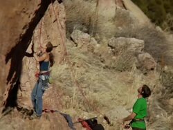 MS Climber walks towards rock and getting ready to climb abd Man holding rope pays close attention /Canon City / Shelf Road, CO, USA Stock Footage