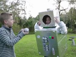 MS Boy and girl play in robot costumes. Stock Footage