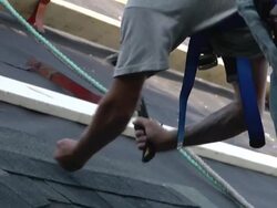 MS SLO MO Worker hammering on roof / Chelsea, Michigan, United States Stock Footage