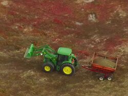 WS ARIEAL View of Bulldozer pulling trolley at field / Maine, United States Stock Footage