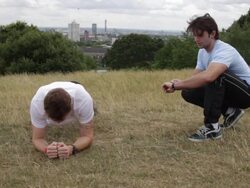 Male fitness exercise in park with personal trainer Stock Footage