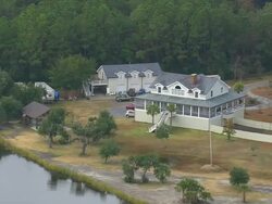 MS AERIAL Shot of wooden house at bank of river near wooded area / South Carolina, United States Stock Footage