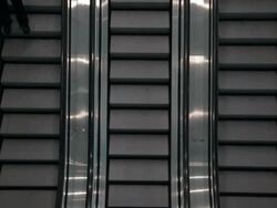 DA Businessman riding one of three escalators as he is typing on his cell phone / Seattle, Washington, United States Stock Footage