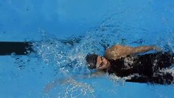 HD Super Slow-Mo: Young Woman Swimming Backstroke Stock Footage
