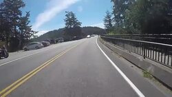 A rural road on San Juan Island near Lime Kiln State Park on a warm sunny day. Stock Footage