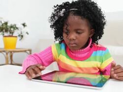 little girl playing on digital tablet Stock Footage
