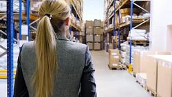 Female manager walking in storage room Stock Footage