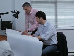 MS PAN Architect and colleague talking and working on blueprint in studio / Vancouver, BC, Canada Stock Footage