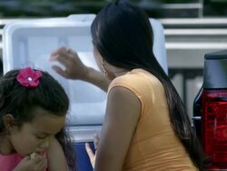Up close view of mother handing cookie to daughter then drinking a soda. Stock Footage