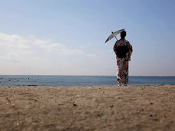 Japanese woman standing by the sea Stock Footage