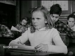 1947: SOCIAL QUESTIONNAIRE: DRAMATIZATION: CU 'Guess Who?' questaionnaire for children. Teacher giving instruction. CU Pencil filling in Carl's name on questionnaire. Boy then girl glancing at 'Carl'. CU Pencil filling in Carl's name on questionnaire. Instructional Video