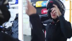 young blonde measures the biker clothes before the mirror Stock Footage