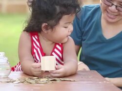 Cute boy with mother learn to count money Stock Footage
