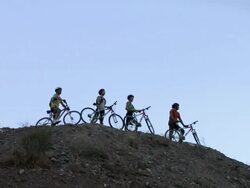Mountain bikers standing on hill, zoom out Stock Footage
