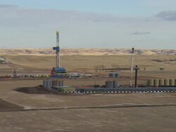 MS AERIAL DS Shot of two oil drilling rigs in Bakken oil field near Watford City / Watford City, North Dakota, United States Stock Footage