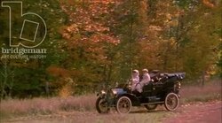 Man and woman driving in a car in the countryside, 1908 - reenactment Stock Footage