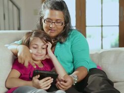 CU PAN Mother and daughter reading from tablet / Santa Fe, New Mexico, United States Stock Footage